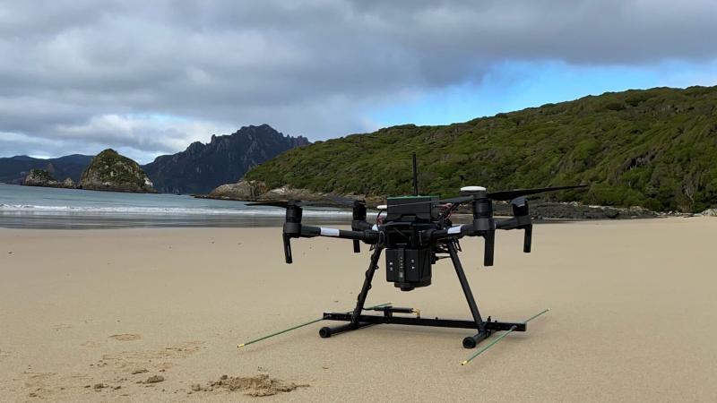 Drone sitting on sandy beach